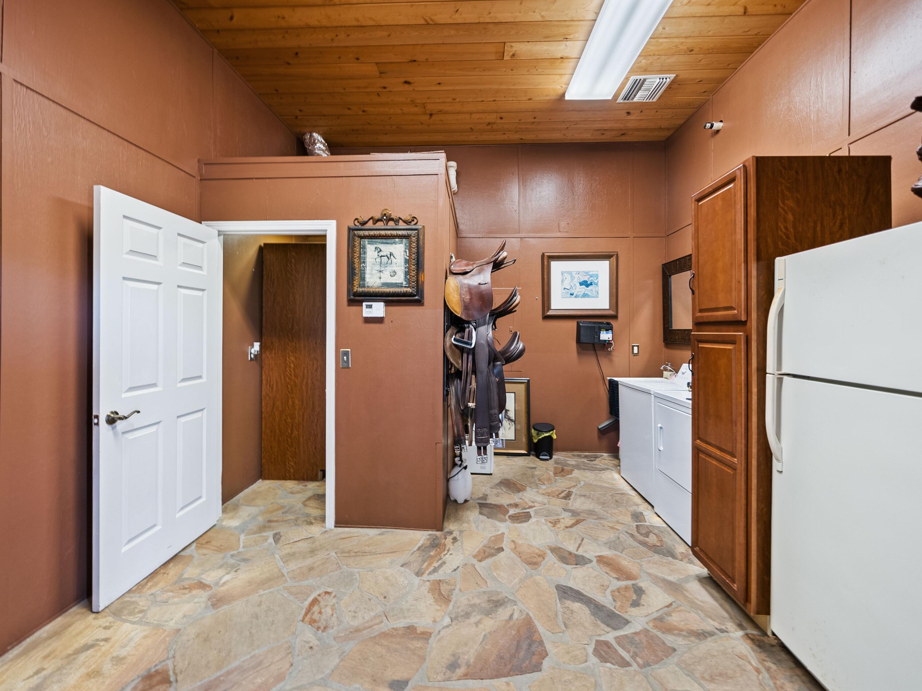 5676 Highway 2 DeFuniak Springs, FL 32433 - Photo 32 of 42 a view of a refrigerator in kitchen and utility room with closet