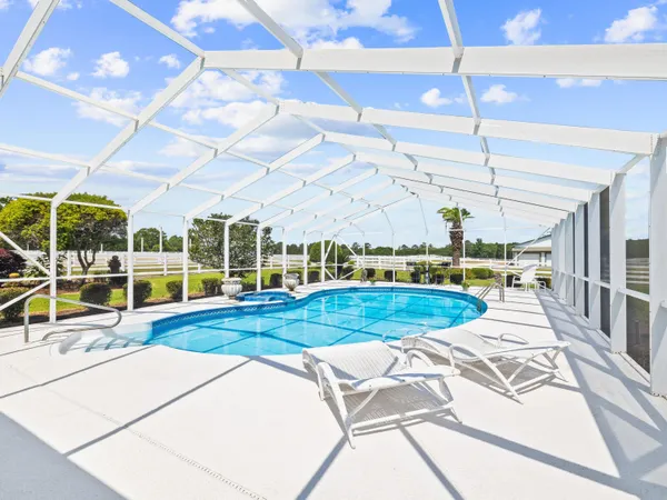 a view of a backyard with swimming pool