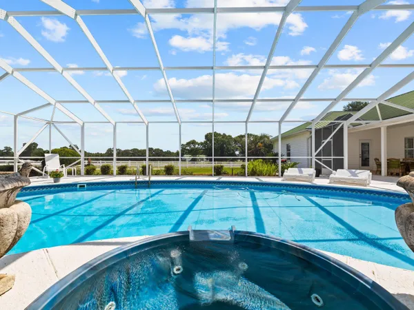 a view of a swimming pool with seating area