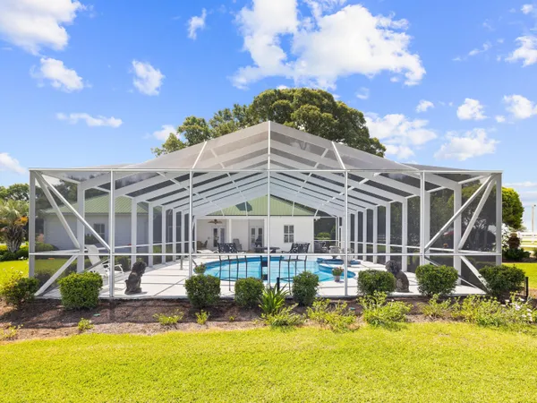 a view of a house with swimming pool and sitting area