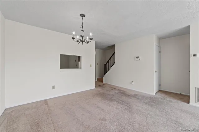 a view of a chandelier fan and entryway