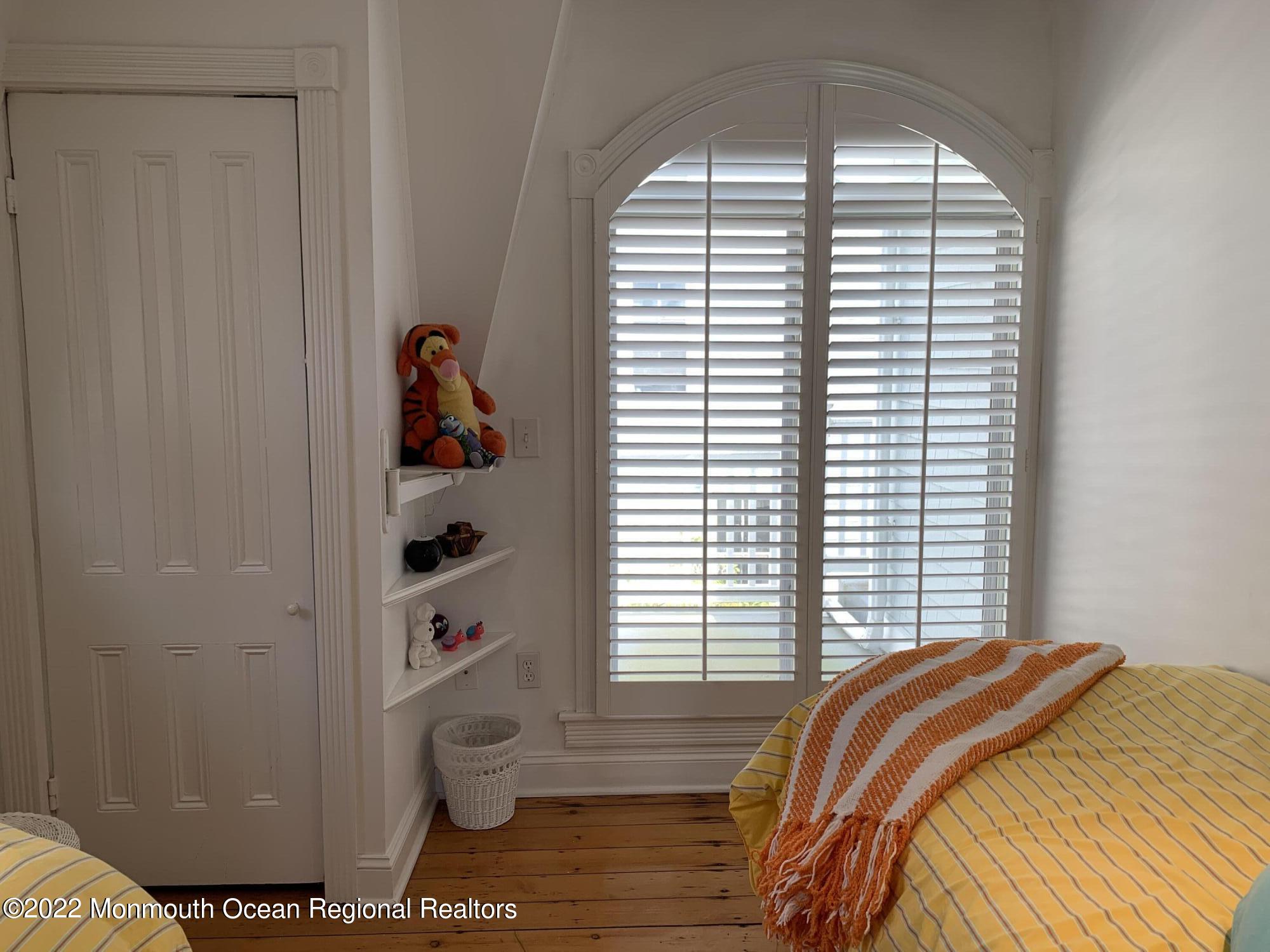 13 Heck Avenue Ocean Grove, NJ 07756 - Photo 14 of 25 a bedroom with a bed and a window