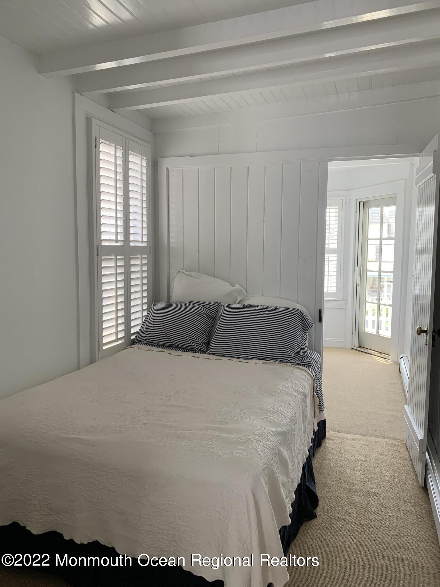 13 Heck Avenue Ocean Grove, NJ 07756 - Photo 16 of 25 a bed sitting in a spacious bedroom next to a window