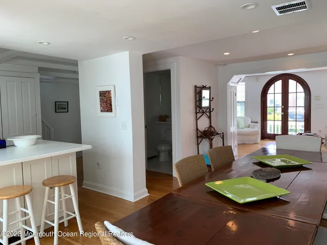 a living room with furniture a rug and a table