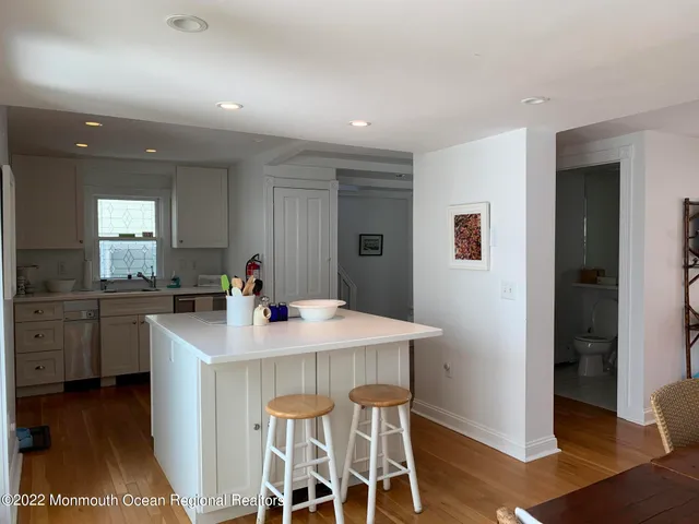 a kitchen with stainless steel appliances kitchen island granite countertop a sink and cabinets