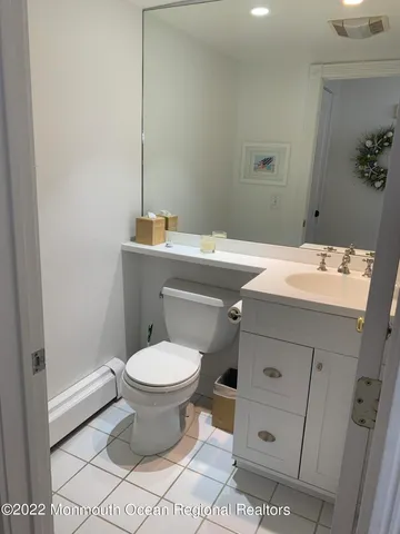 a bathroom with a sink toilet and a mirror