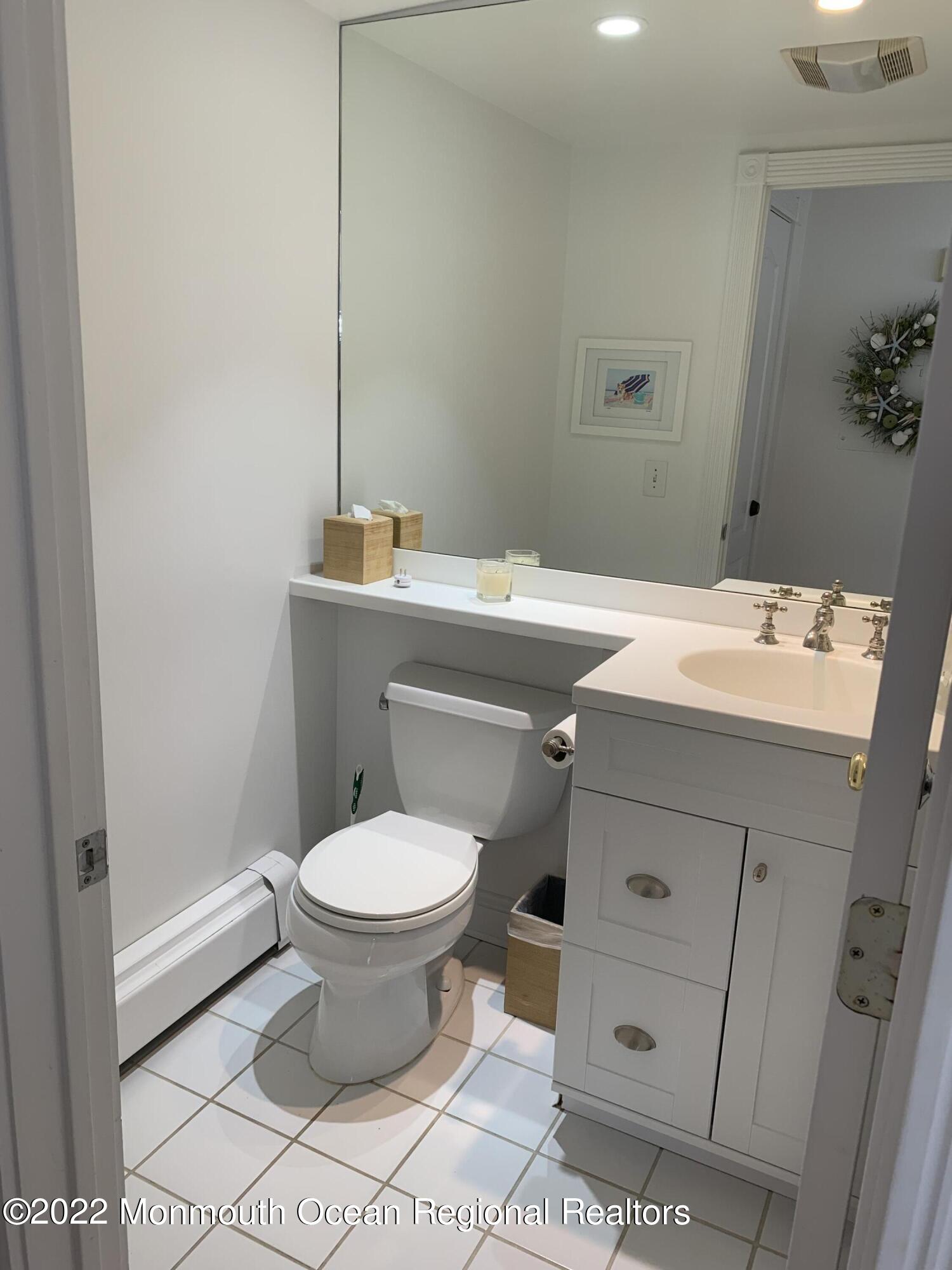 13 Heck Avenue Ocean Grove, NJ 07756 - Photo 10 of 25 a bathroom with a sink toilet and a mirror