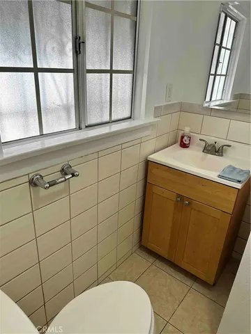a bathroom with a sink toilet and window
