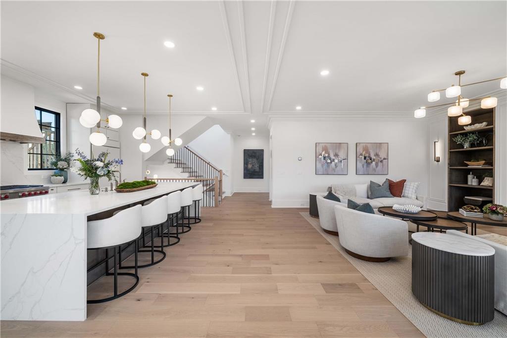 257 Lask Lane Milton, GA 30004 - Photo 11 of 84 a large room with kitchen island a large counter top space a sink a window and living room view