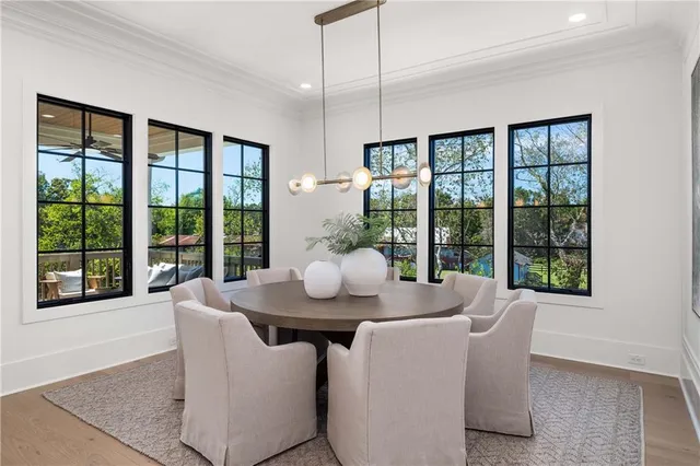 a bedroom with a bed a potted plant and a dresser