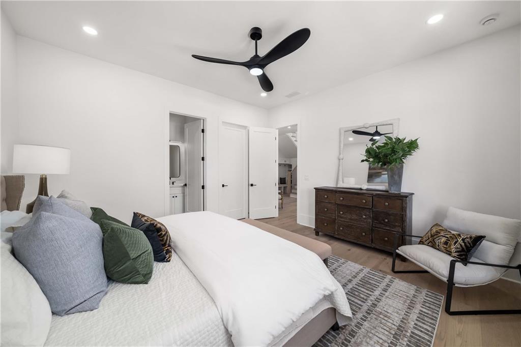 257 Lask Lane Milton, GA 30004 - Photo 25 of 84 a bedroom with a bed a potted plant and a dresser