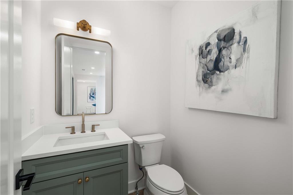 257 Lask Lane Milton, GA 30004 - Photo 37 of 84 a bathroom with a toilet sink and mirror