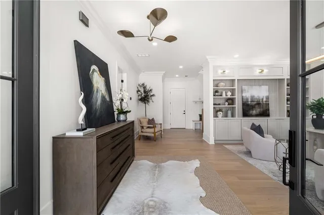 a large room with kitchen island a large counter top space a sink a window and living room view