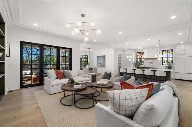 a large kitchen with stainless steel appliances a stove a sink a oven and a kitchen island