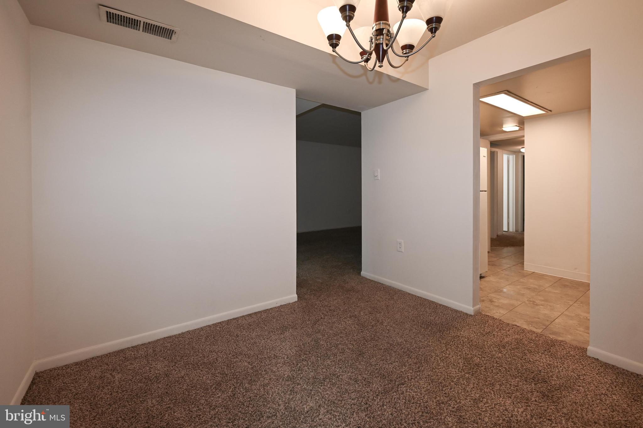 1532 Northgate Square, Unit 15322A Reston, VA 20190 - Photo 7 of 16 an empty room with a chandelier fan and closet