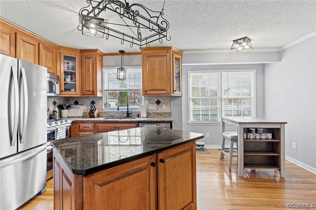 6441 Blair Court Prince George, VA 23875 - Photo 15 of 46 a kitchen with stainless steel appliances granite countertop a refrigerator a sink dishwasher a stove and a dining table with wooden floor