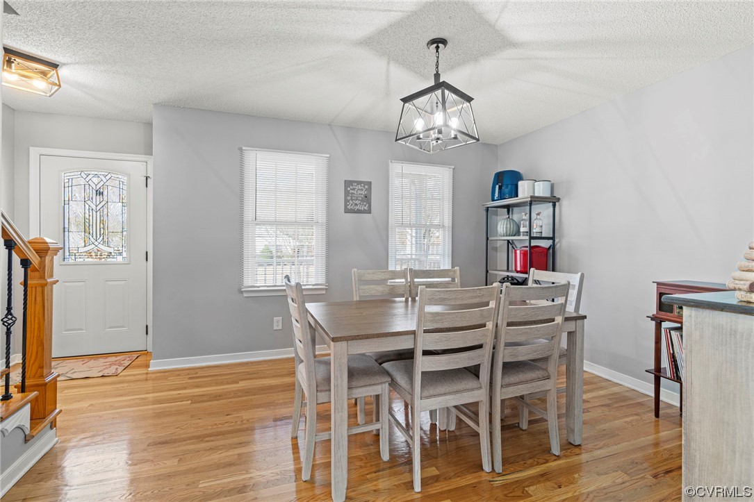 6441 Blair Court Prince George, VA 23875 - Photo 17 of 46 a view of a dining room with furniture a chandelier and wooden floor