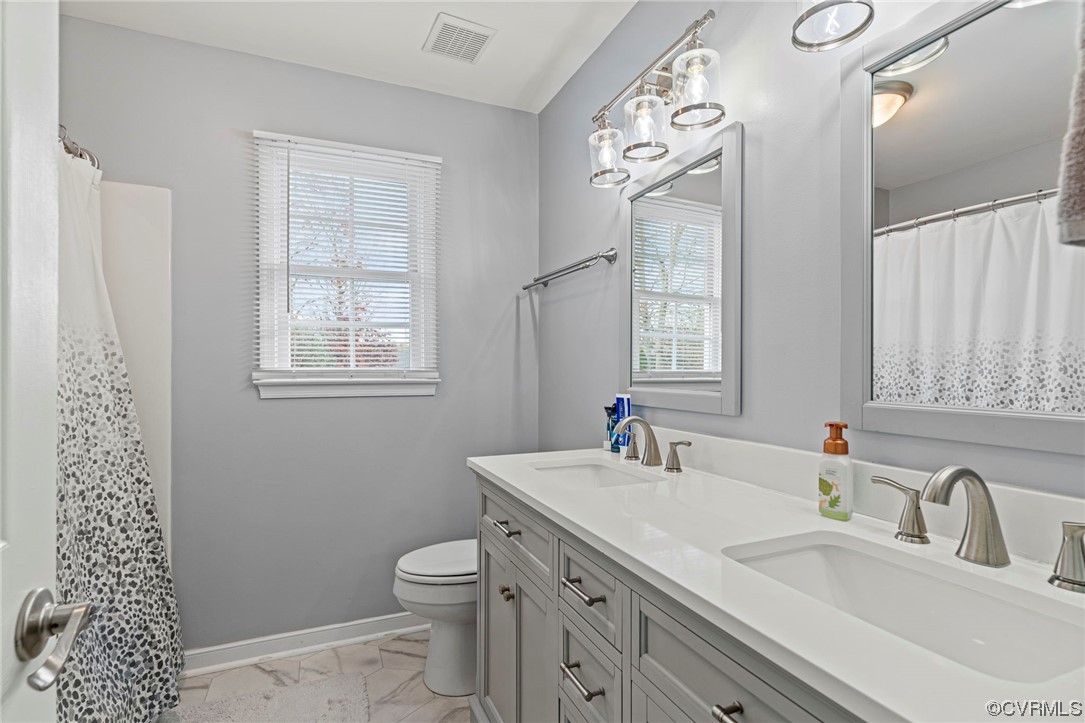 6441 Blair Court Prince George, VA 23875 - Photo 29 of 46 a bathroom with a sink a toilet and a window