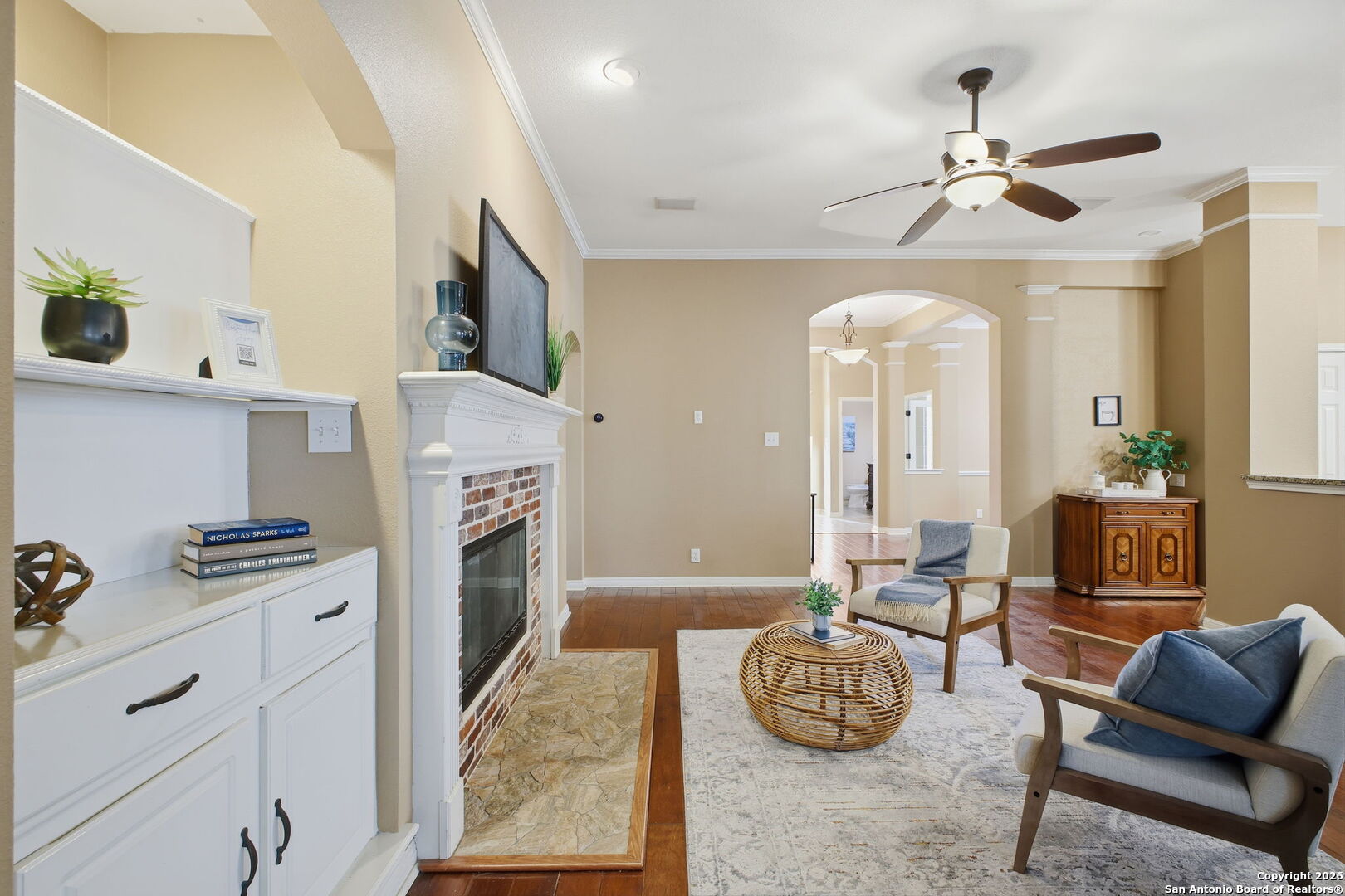 527 Mesa Ridge San Antonio, TX 78258 - Photo 14 of 36 a living room with furniture a fireplace and a chandelier