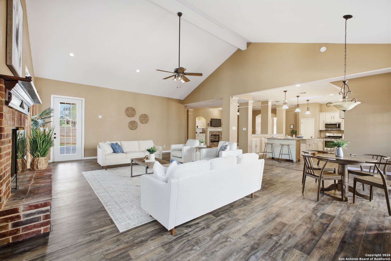 527 Mesa Ridge San Antonio, TX 78258 - Photo 15 of 25 a living room with furniture a chandelier and a dining table with wooden floor