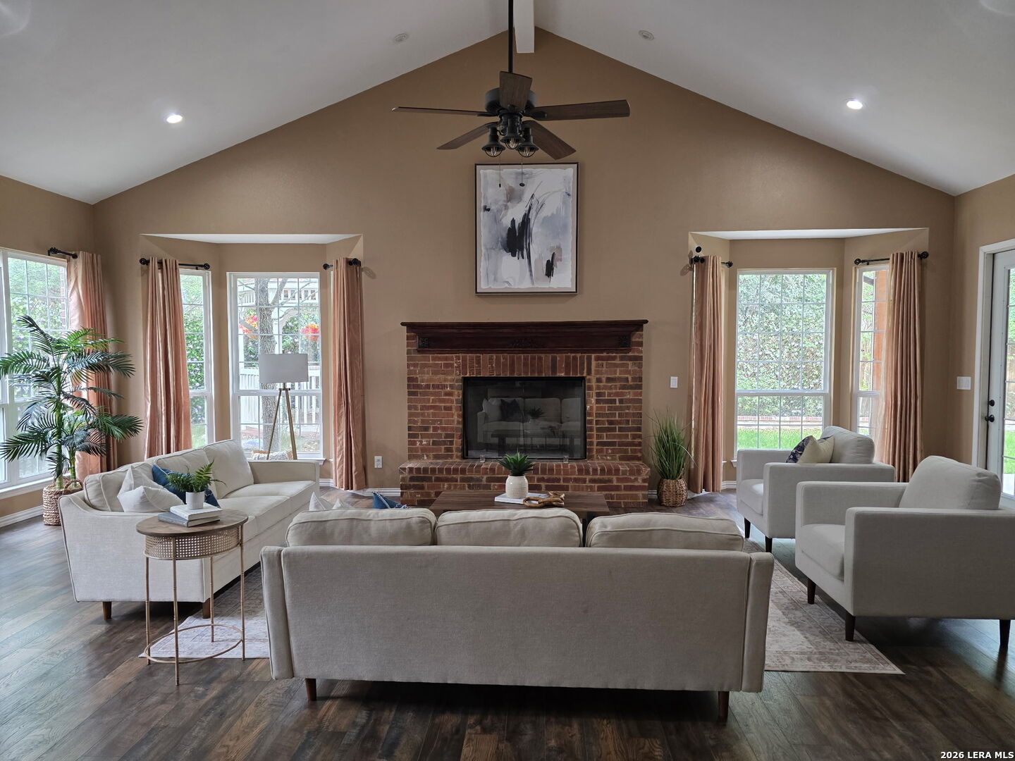 527 Mesa Ridge San Antonio, TX 78258 - Photo 18 of 36 a living room with furniture a fireplace and a large window