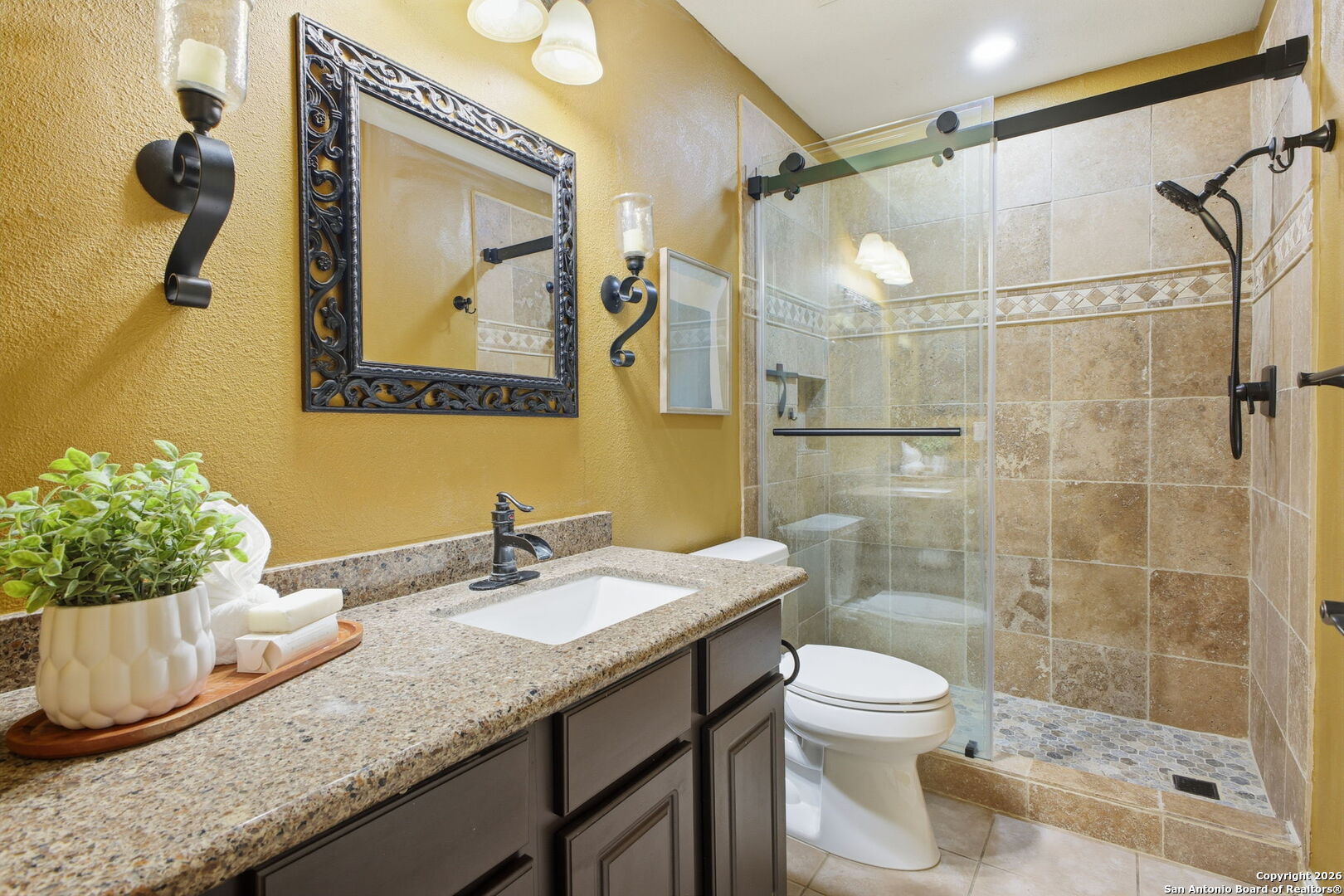 527 Mesa Ridge San Antonio, TX 78258 - Photo 20 of 25 a bathroom with a granite countertop sink a toilet and shower