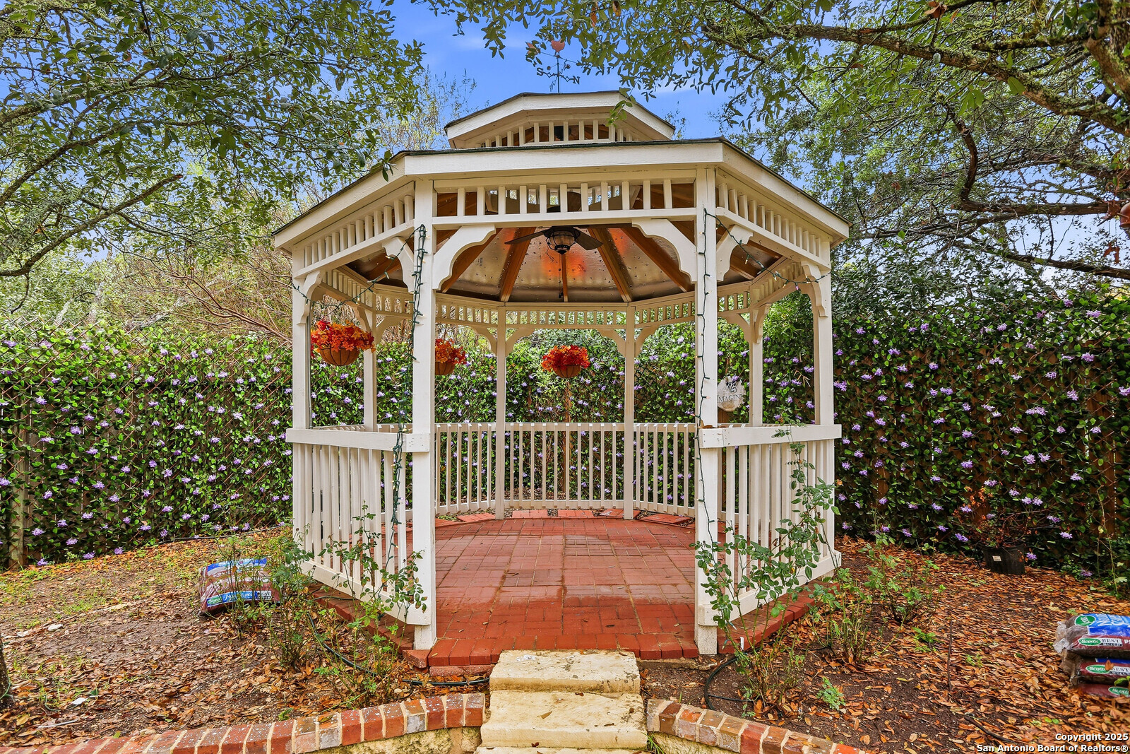 527 Mesa Ridge San Antonio, TX 78258 - Photo 24 of 25 a view of a wooden house with a yard