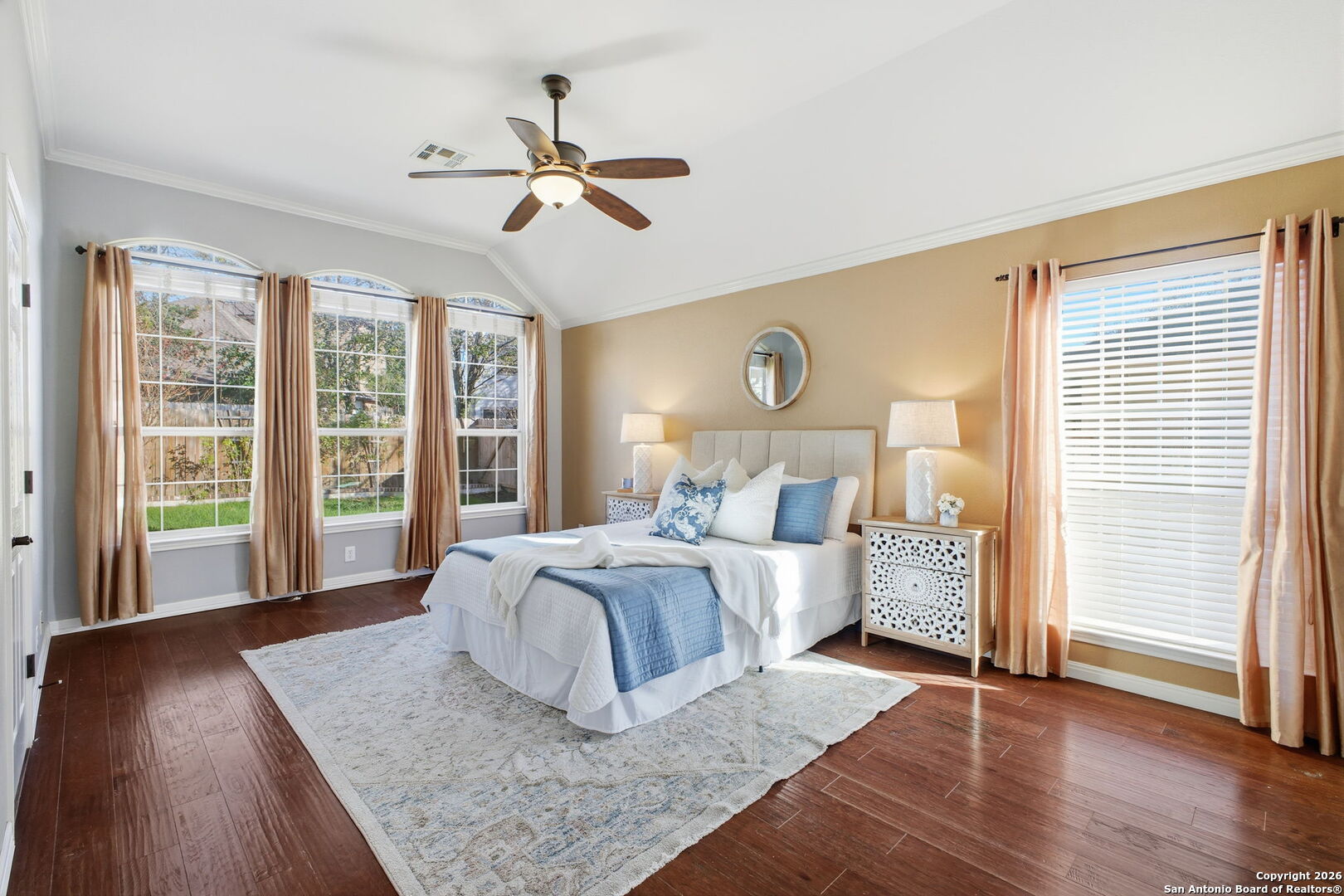 527 Mesa Ridge San Antonio, TX 78258 - Photo 24 of 36 a bedroom with a large bed and wooden floor