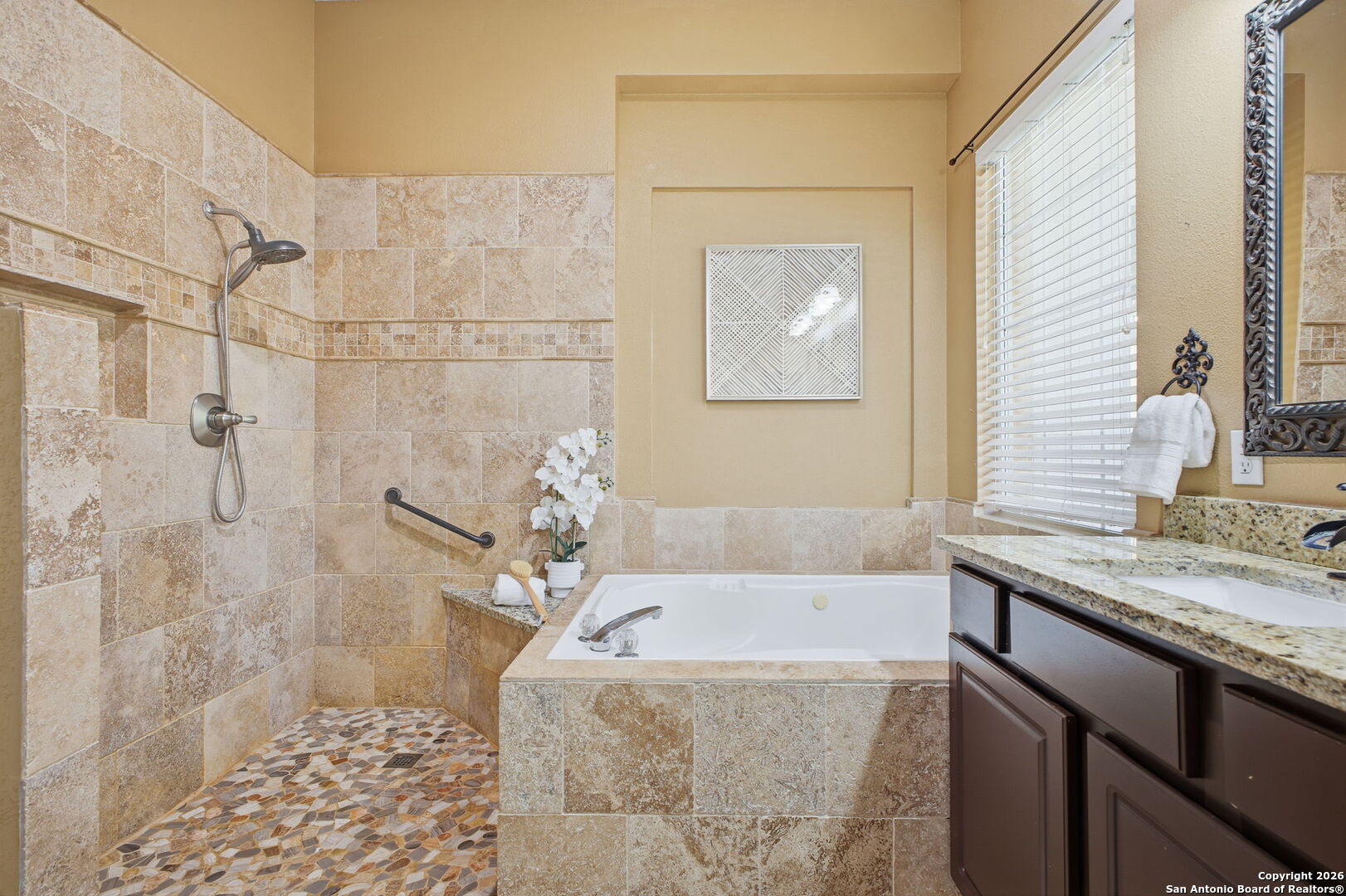 527 Mesa Ridge San Antonio, TX 78258 - Photo 26 of 36 a bathroom with a granite countertop sink a toilet and shower