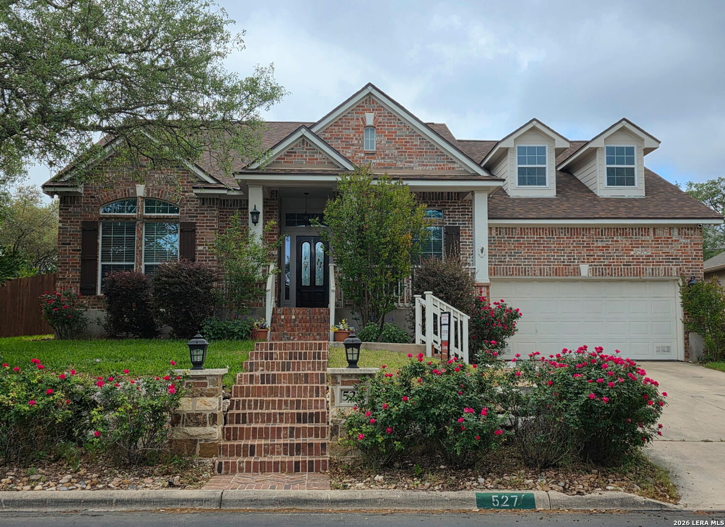 527 Mesa Ridge San Antonio, TX 78258 - Photo 3 of 36 a front view of a house with a yard and potted plants
