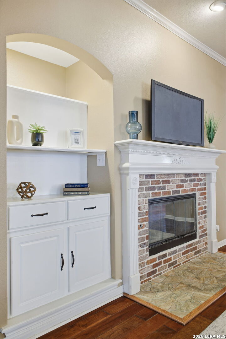 527 Mesa Ridge San Antonio, TX 78258 - Photo 9 of 25 a living room with furniture and a fireplace