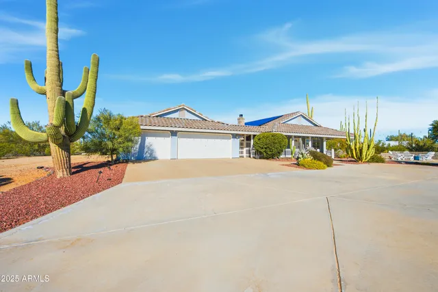 a yellow and red house with a yard