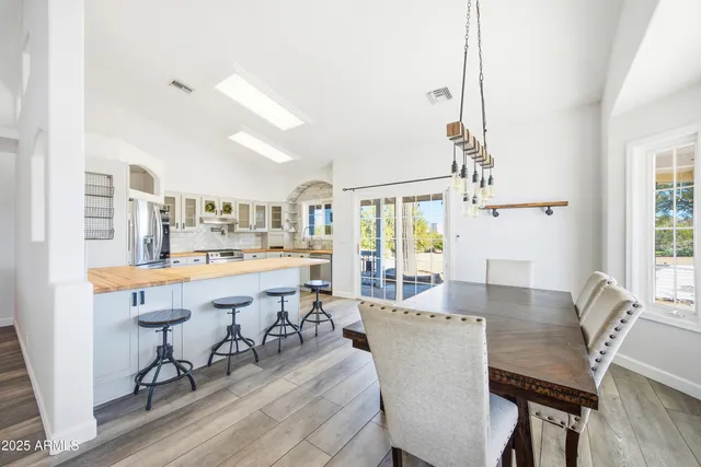 a view of a dining room with a table and chairs