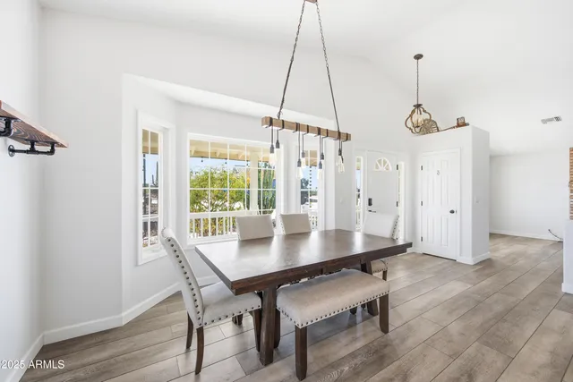 a large kitchen with cabinets and wooden floor