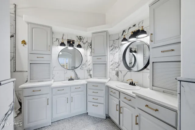 a bathroom with a double vanity sink and a mirror