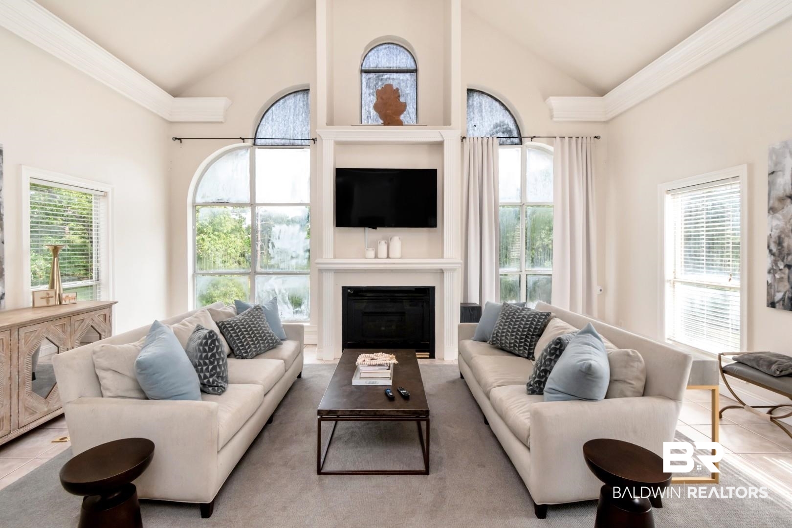 2640 Meadowlake Road Semmes, AL 36575 - Photo 19 of 55 Living area with a high ceiling, a glass covered fireplace, healthy amount of natural light, and tile patterned floors