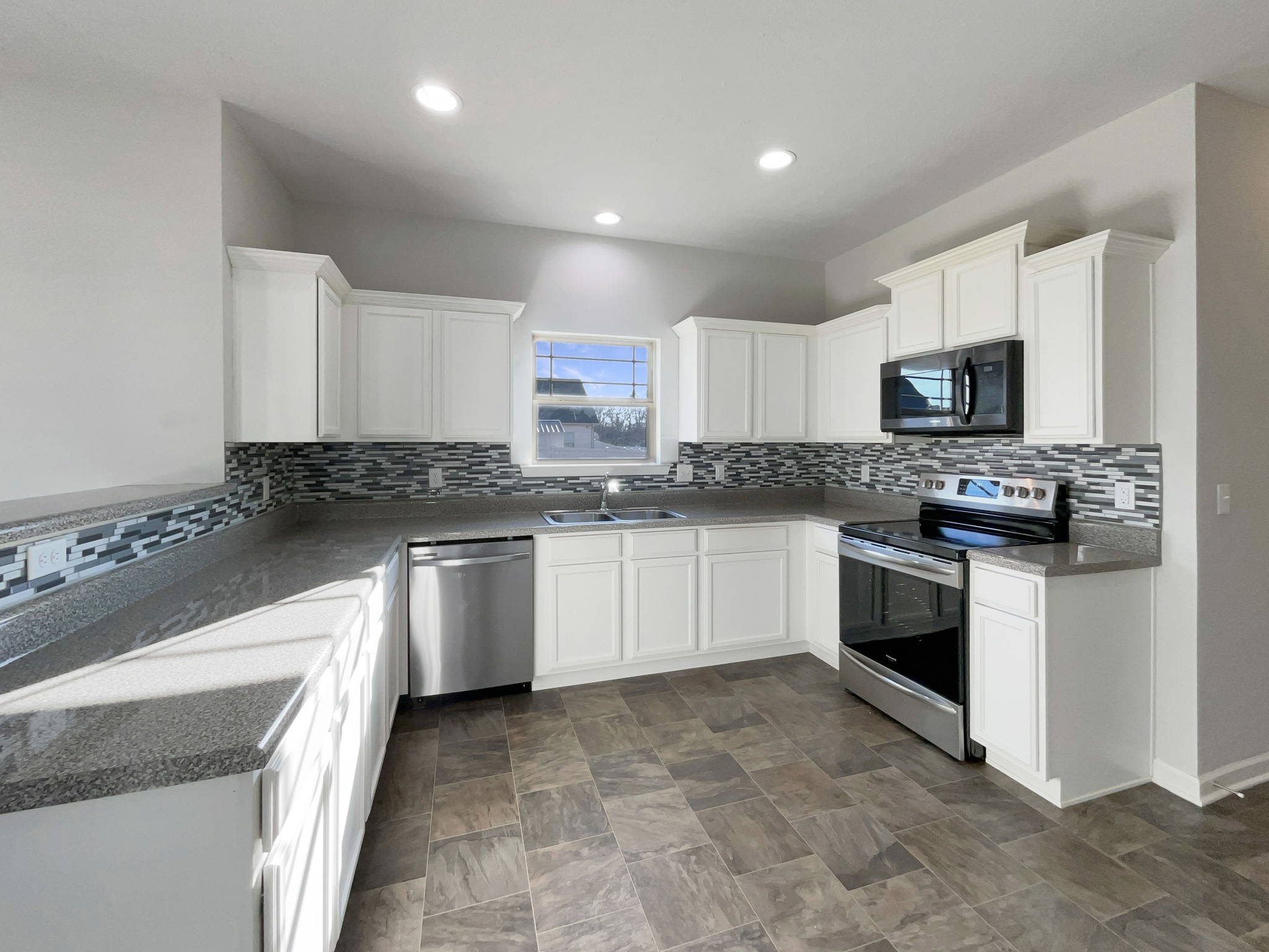 113 Copper Leaf Road Murfreesboro, TN 37128 - Photo 3 of 23 a kitchen with granite countertop white cabinets and stainless steel appliances