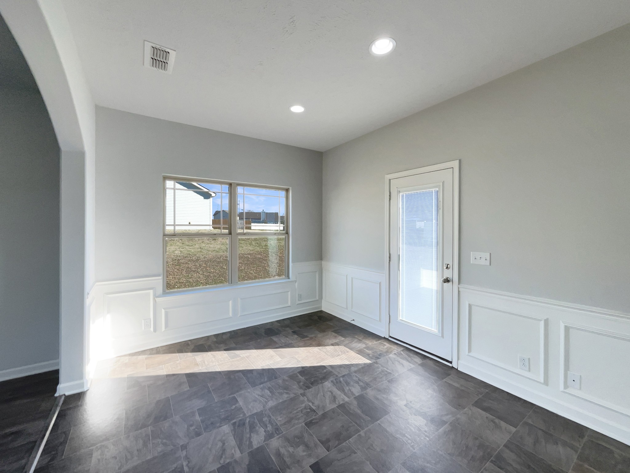 113 Copper Leaf Road Murfreesboro, TN 37128 - Photo 7 of 23 an empty room with wooden floor and windows
