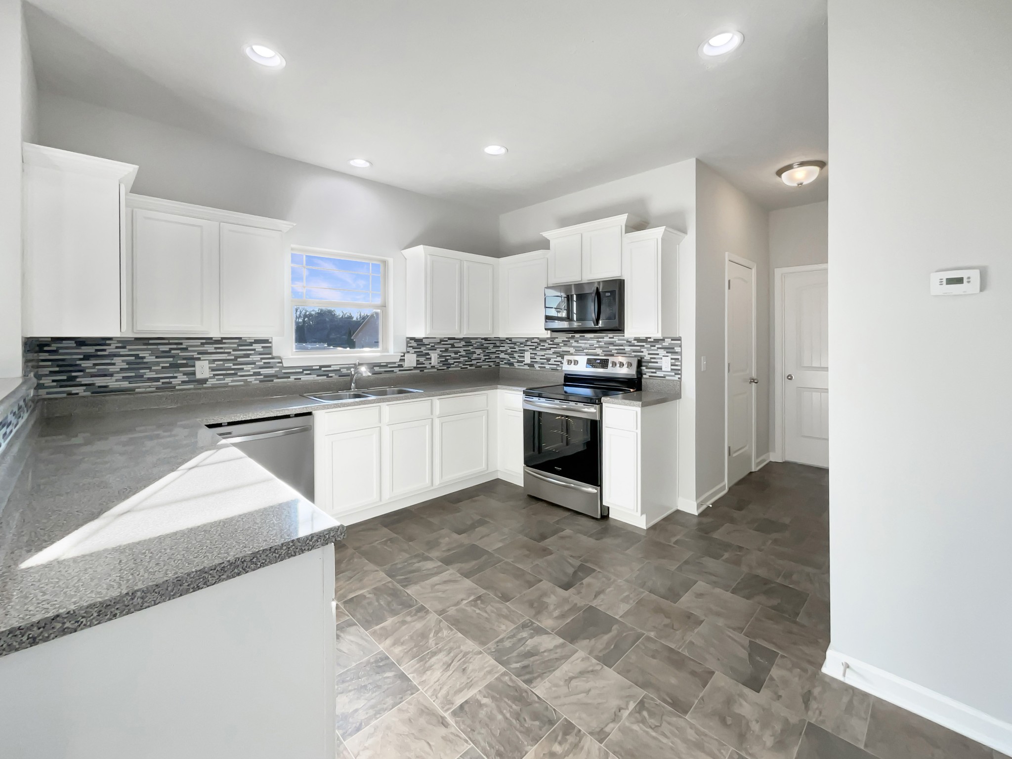 113 Copper Leaf Road Murfreesboro, TN 37128 - Photo 8 of 23 a kitchen with stainless steel appliances granite countertop a stove top oven a sink and a granite counter tops