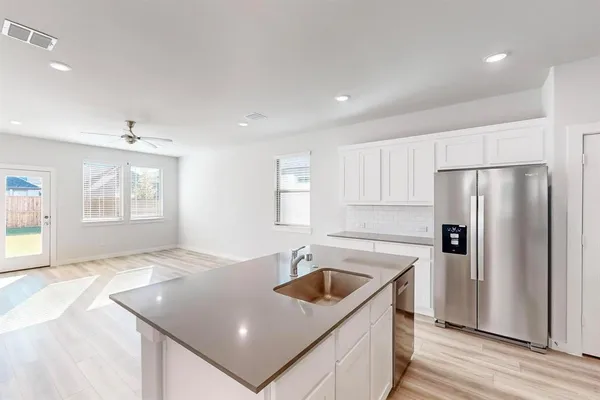 a kitchen that has a sink a refrigerator and a sink