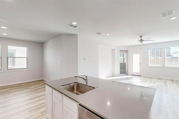 a kitchen with a sink stove and cabinets