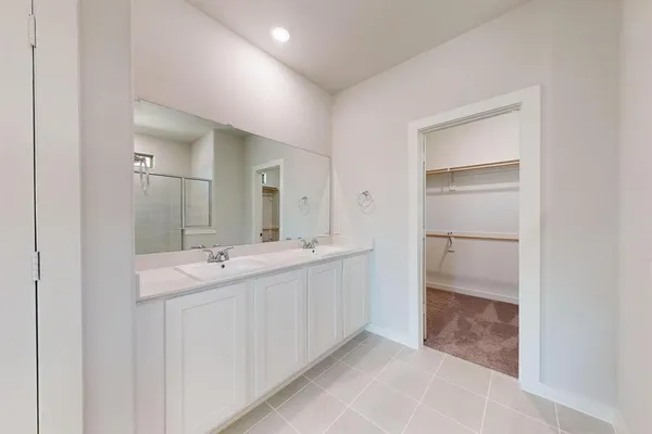 a bathroom with a double vanity sink and mirror