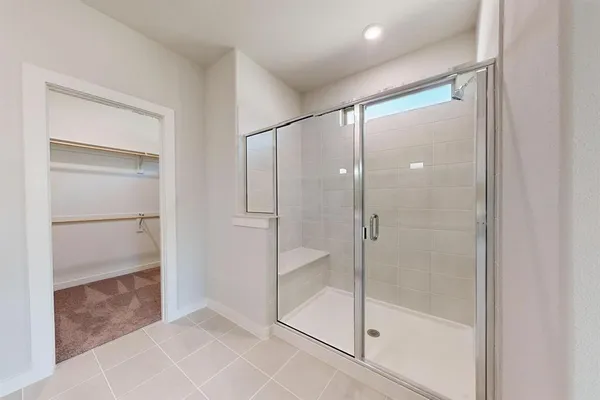 a bathroom with a glass shower door