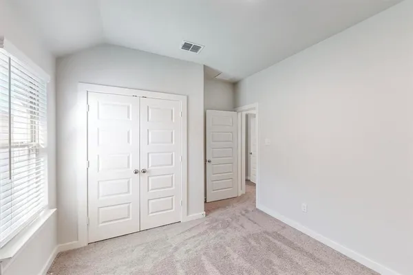 an empty room with closet area