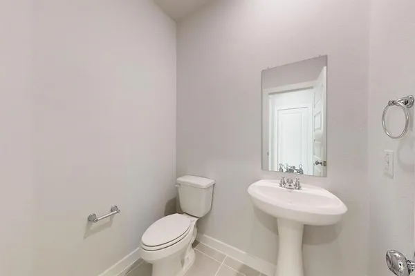 a bathroom with a sink toilet and a mirror