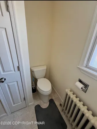 a white toilet sitting next to a sink