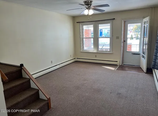 a view of an empty room with a window