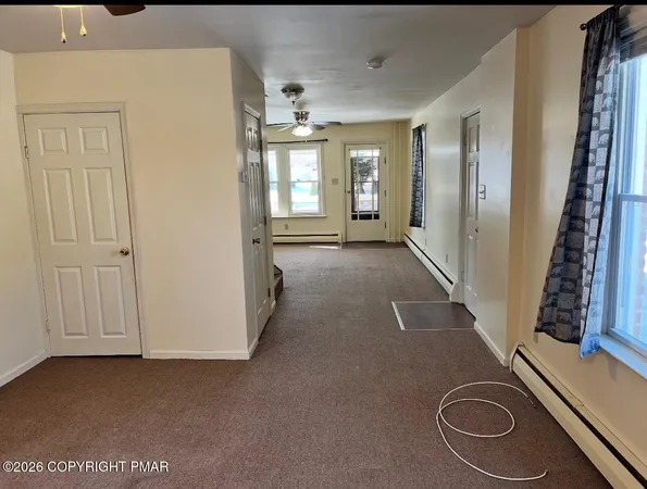 a view of a livingroom with furniture and staircase
