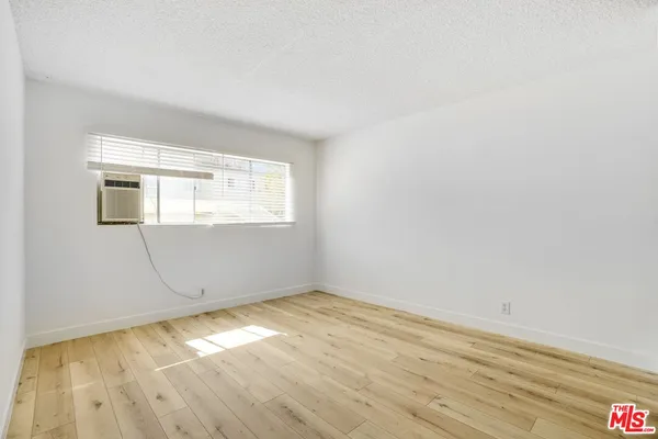 a view of a room with wooden floor and bathroom