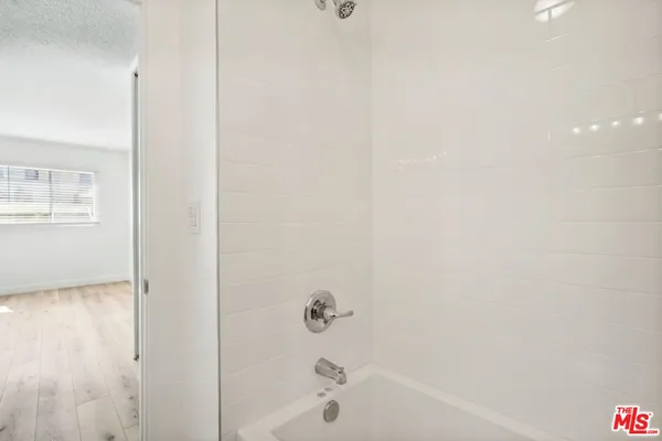 a bathroom with a shower a toilet and sink